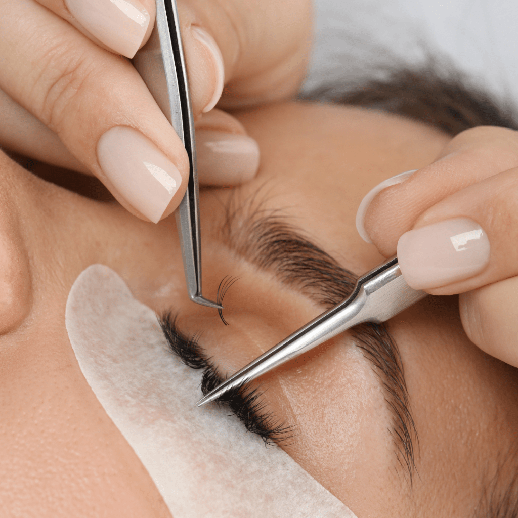 Woman receiving eye lash extensions