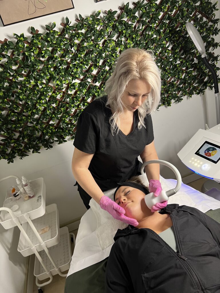 Woman receiving Neveskin face treatment.